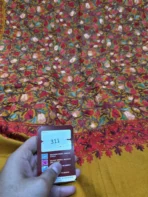 Detail of red and pink floral embroidery on mustard Pashmina fabric 311