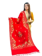 Detail of peach and orange Aari embroidery on red wool fabric